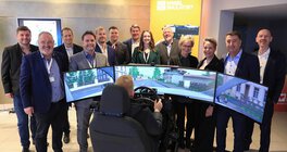 Das Vogel System Messe Team steht um den Simulator